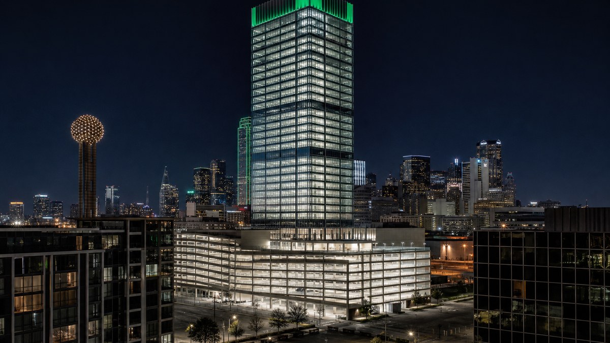 Dallas office tower at dusk after a commercial LED retrofit with evenly lit floors and illuminated parking structure