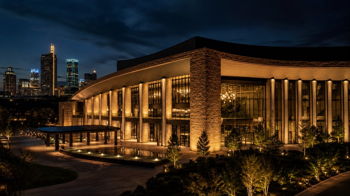 Dallas entertainment venue facade with architectural LED wall washing in gold and amber light at dusk