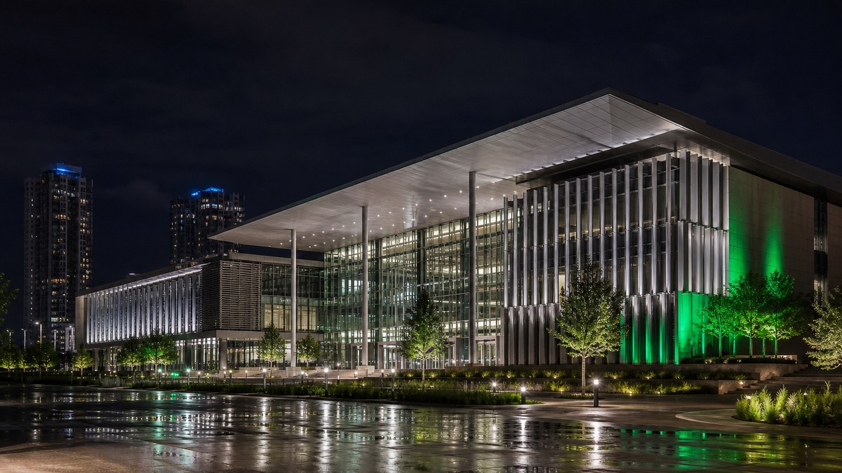 Contemporary event venue and convention center exterior at night with architectural LED facade lighting and illuminated plaza in Texas