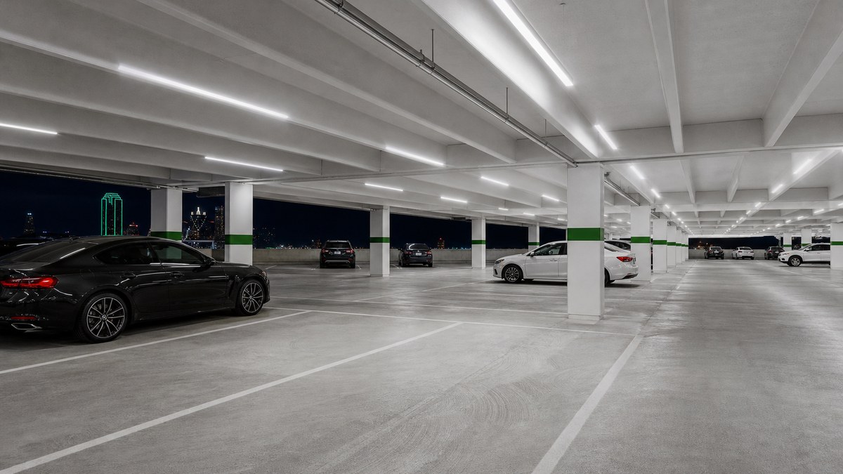 Multi-level parking garage in Dallas with bright uniform LED lighting and clean white ceilings after a commercial LED retrofit